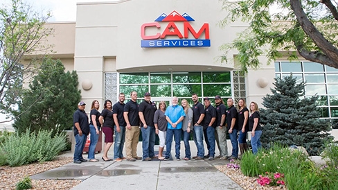 cam services team in front of their building